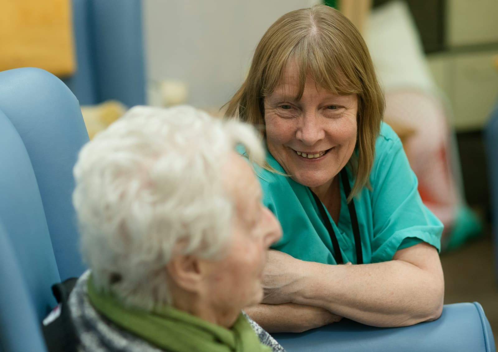 Long term care staff helping an older woman