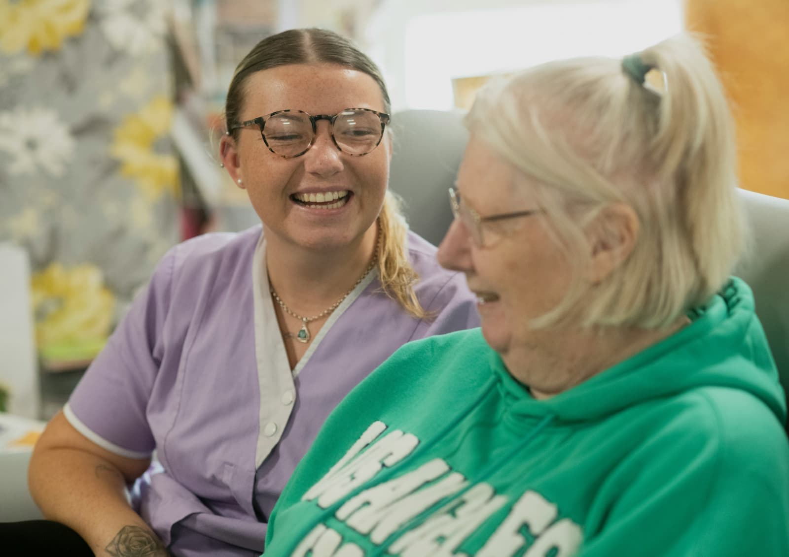 Caregiver and older adult enjoying conversation together